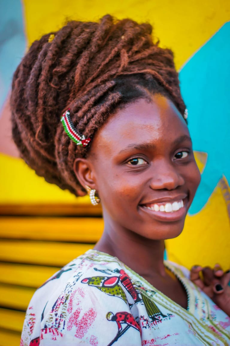 Cheerful client showing intricate loc styling